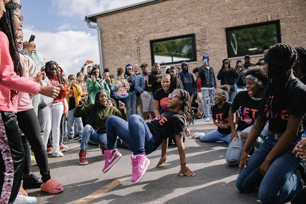 Art in Motion students dance outside the school