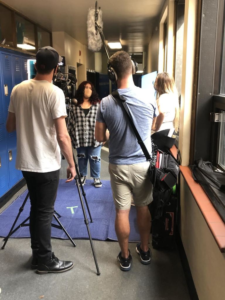 Camera crew films an interview with a student
