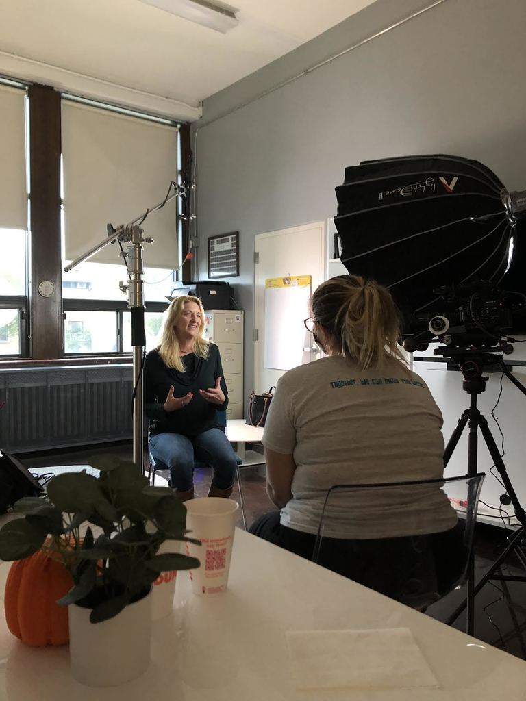 Camera crew films an interview with a teacher